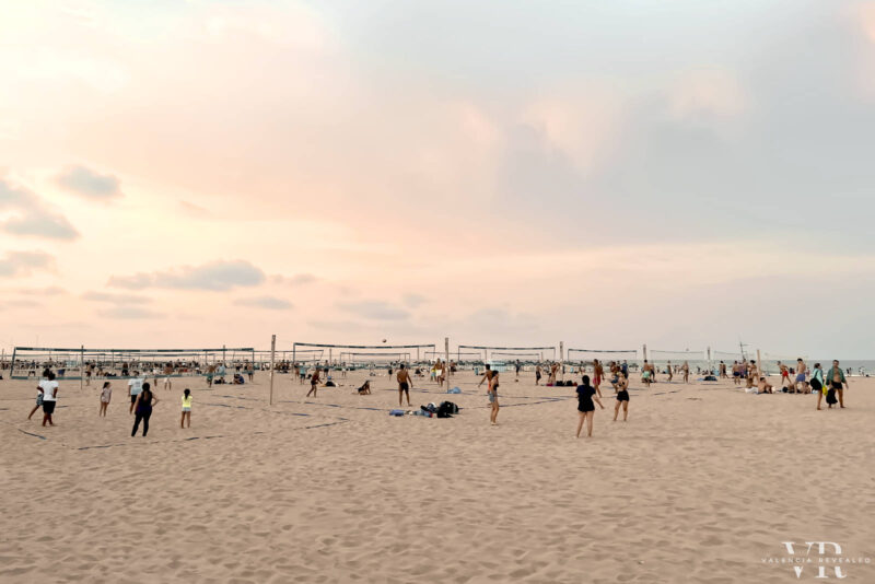 People playing beach ball at sunset on Malvarrosa Beach in Valencia