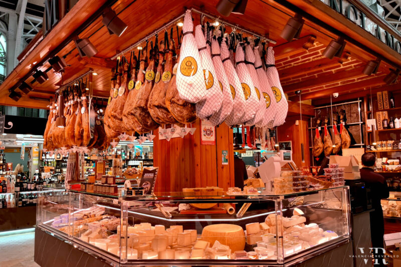 Hanging hams and cheeses inside the Central Market in Valencia