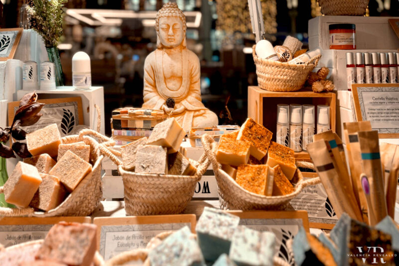 Baskets of handmade soap with the figure of Buddha in the background