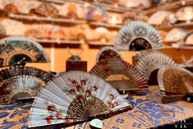 Colorful Spanish fans on display inside a stall at a Christmas market