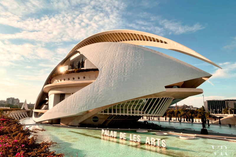 The futuristic building of Reina Sofía Opera House surrounded by pools of water and vegetation