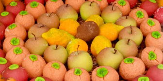 Fruit shaped marzipan sweets arranged in concentric circles