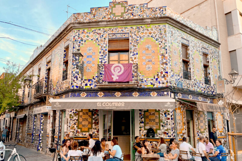 A popular bar in Banimaclet with a colorful facade and a sidewalk terrace
